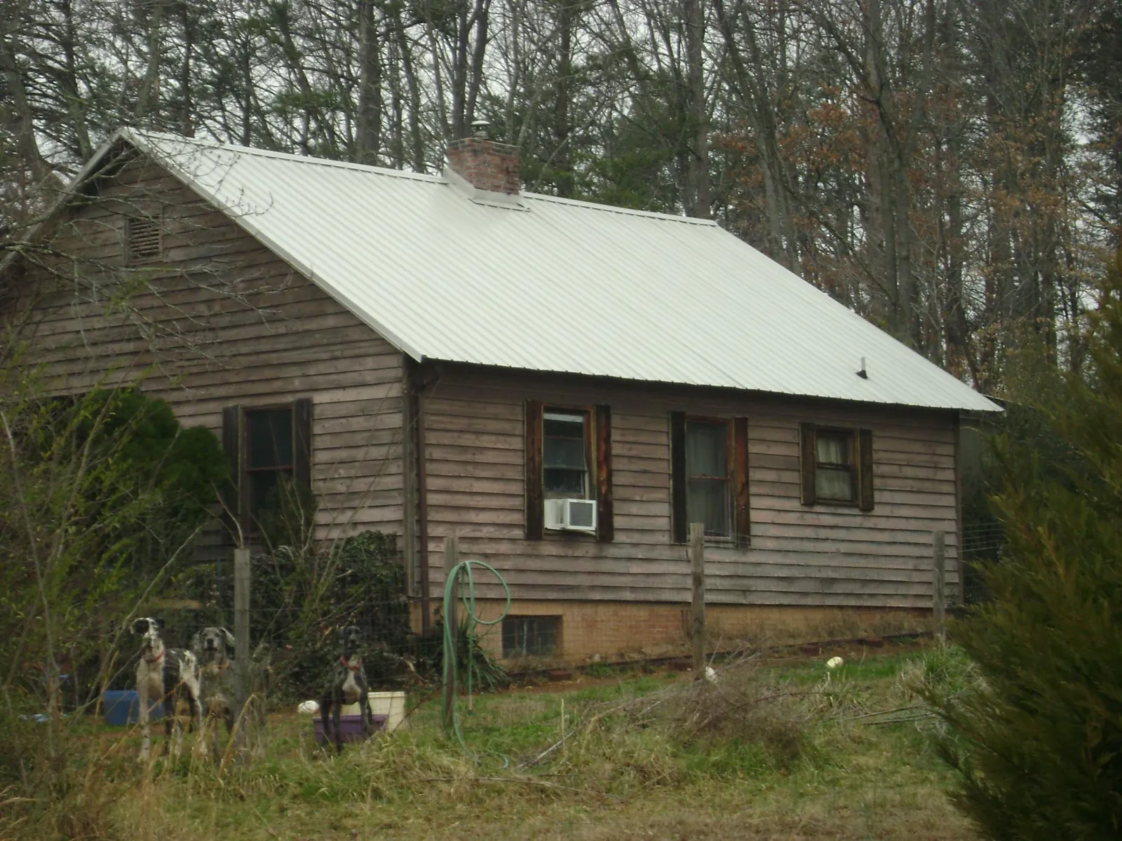 White metal roof on an old wood sided farmhouse, from a Metal Roof Installation job in Goldsboro